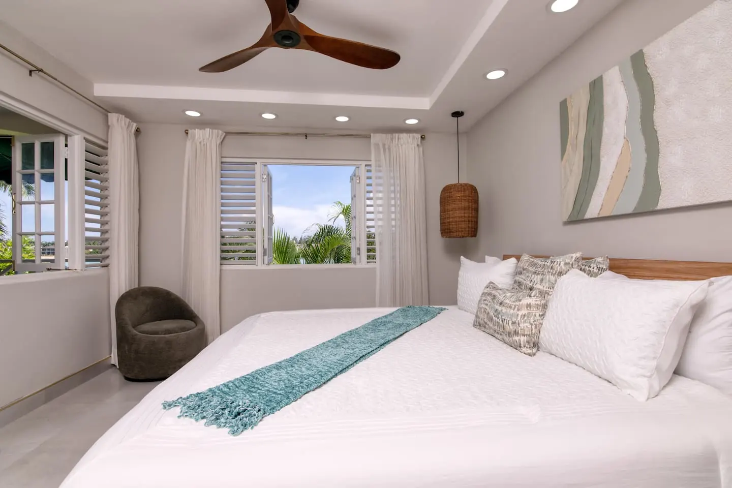 Bedroom 1: king bed and seating beside the windows.