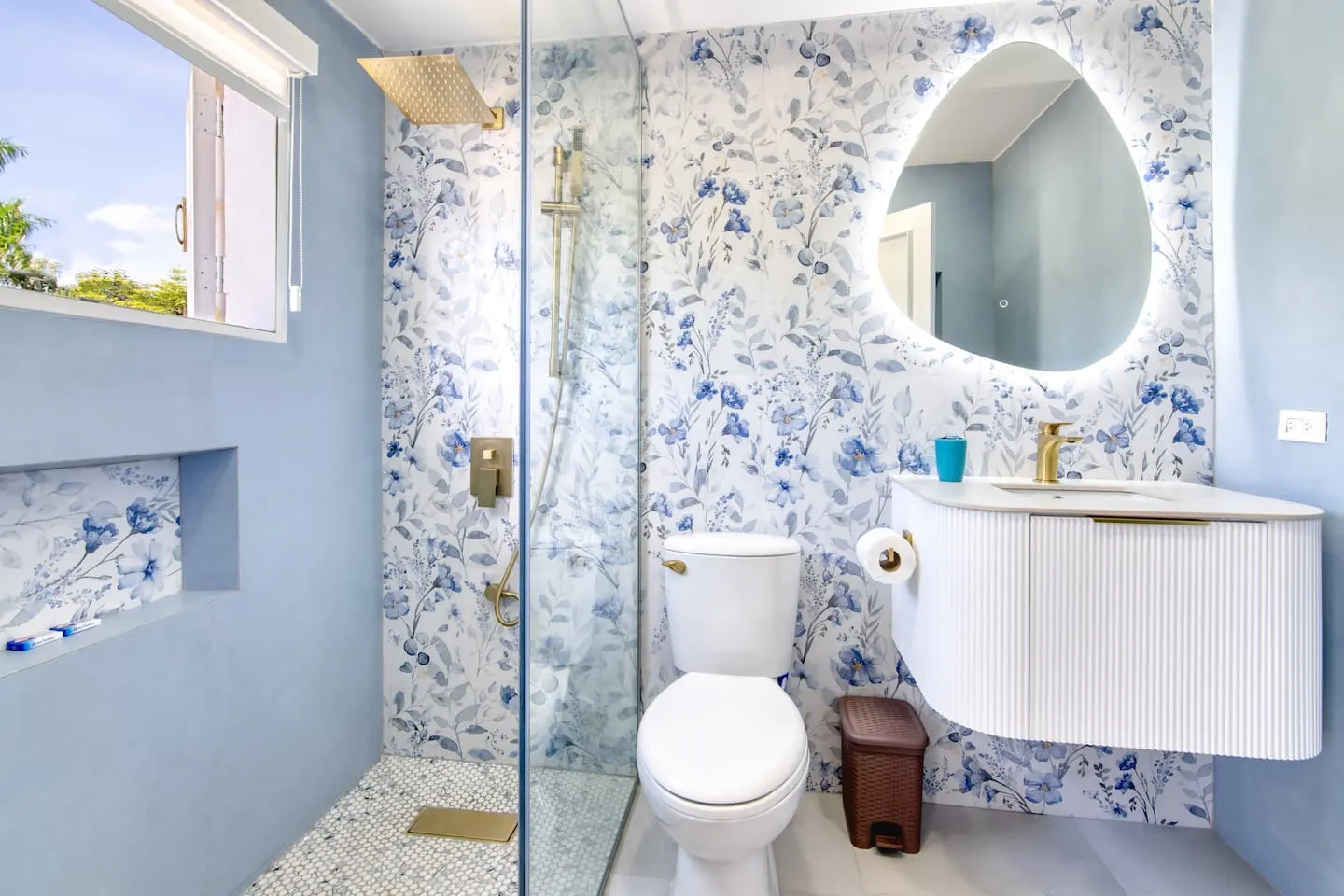 Bathroom 1: glass shower enclosure, vanity and toilet.