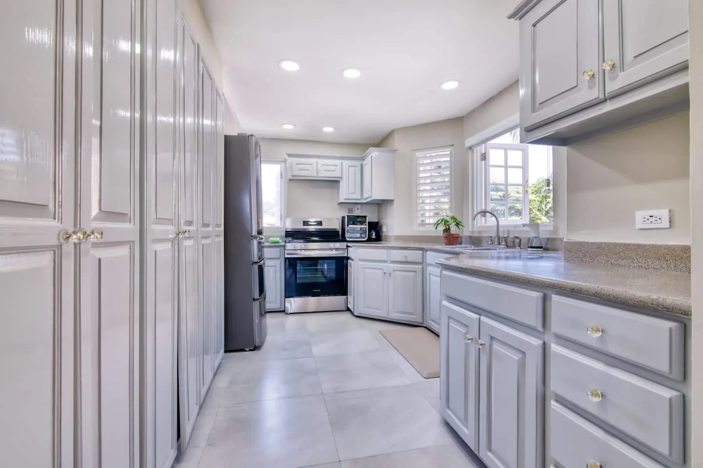 Kitchen with refrigerator, stove, oven and counter appliances.